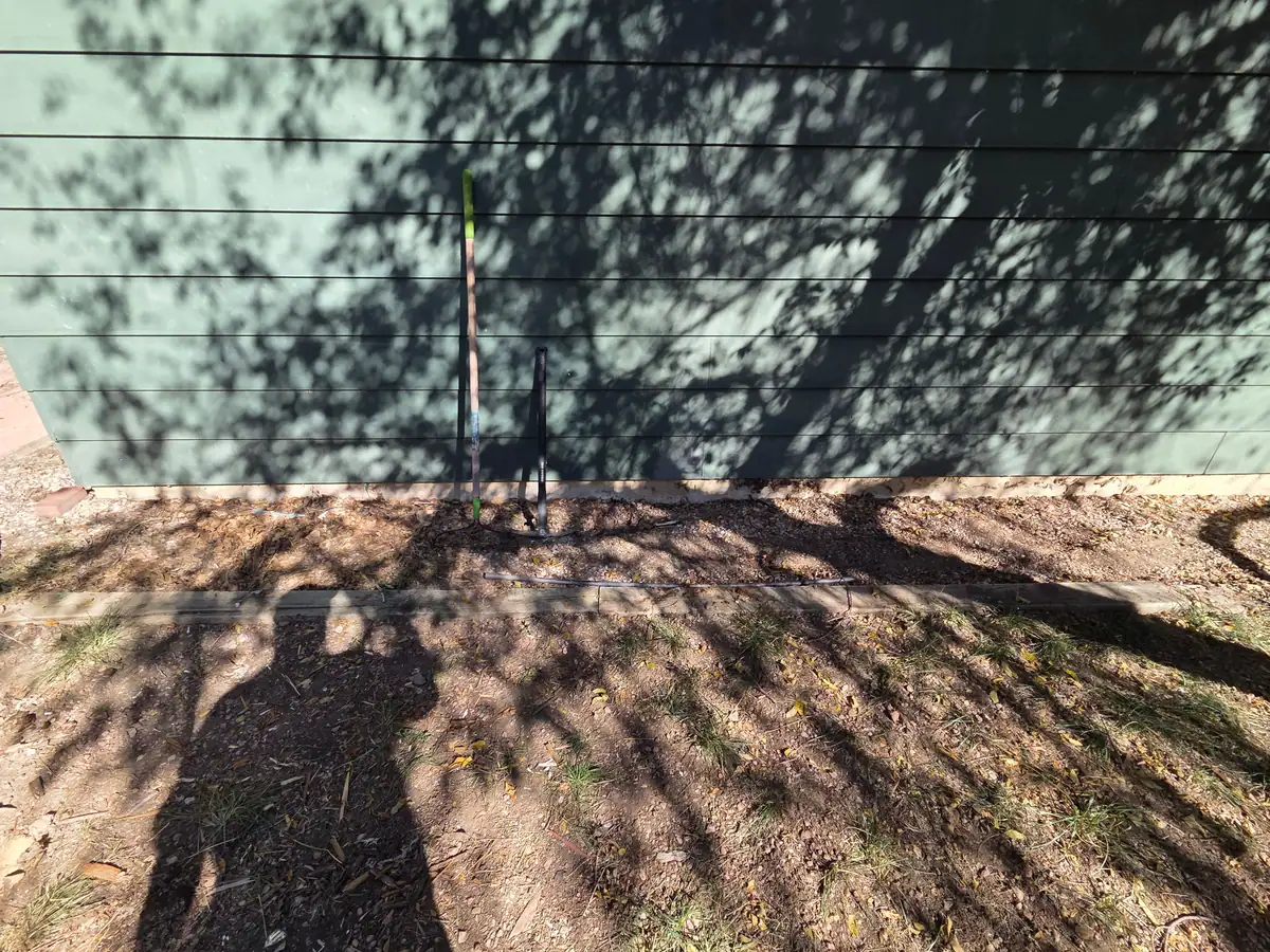 The same spot along the siding cleared to bare ground
