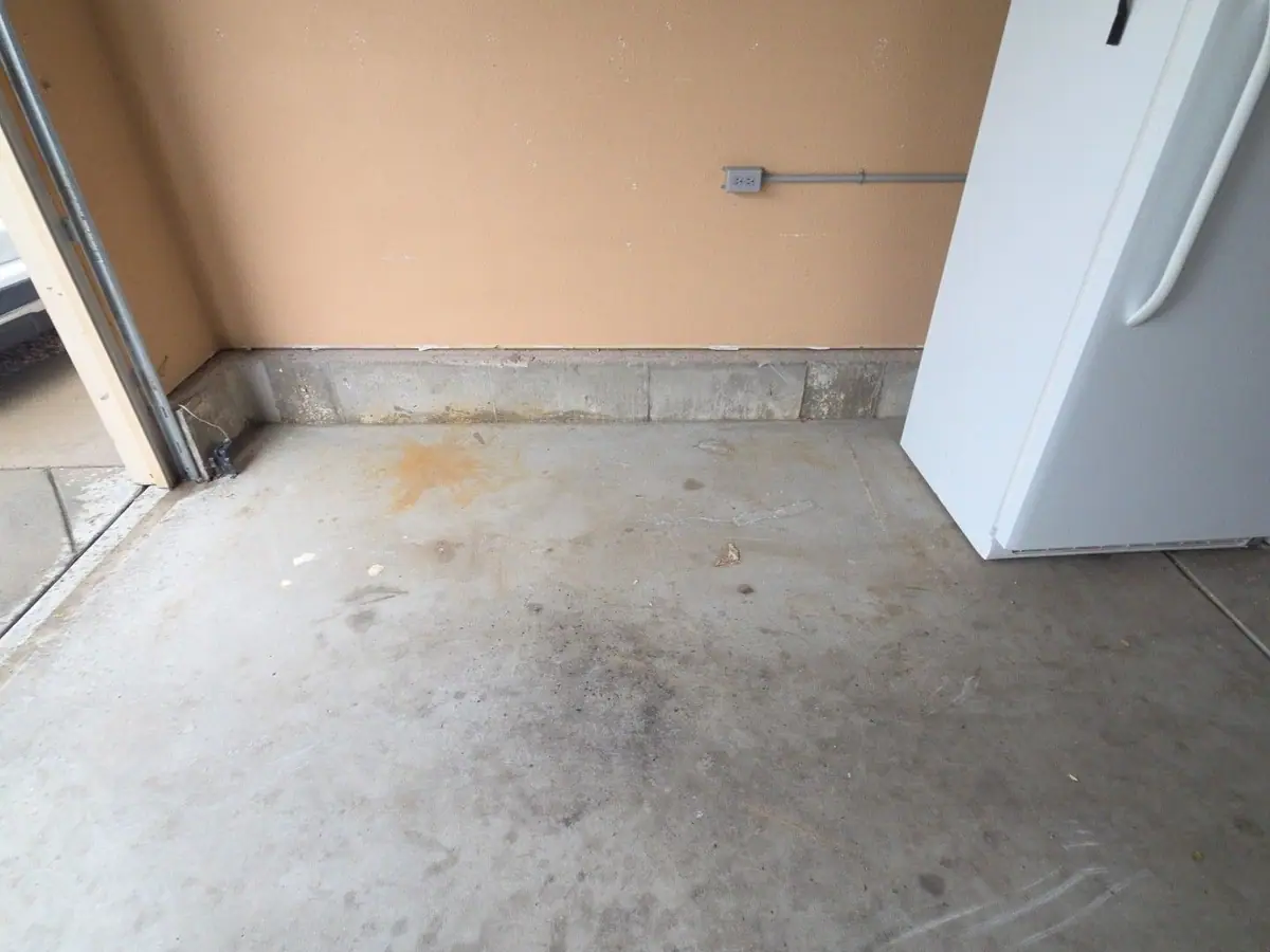The same garage swept clean with the couch hauled away