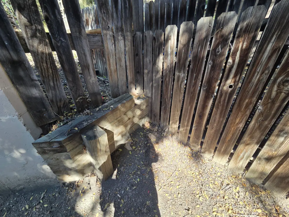 The same fence corner cleared with one planter box left