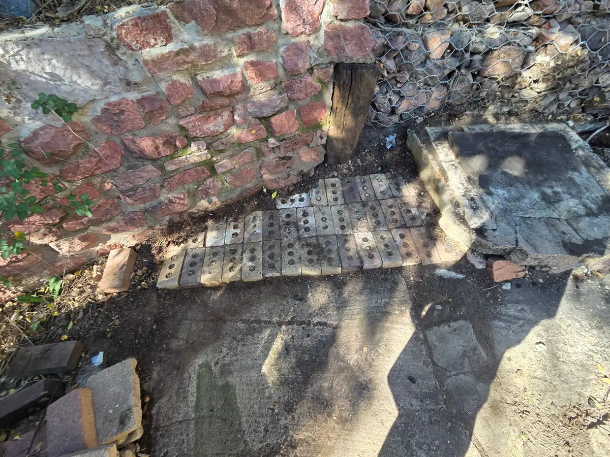 The same spot by the brick wall with the pallet and boards gone