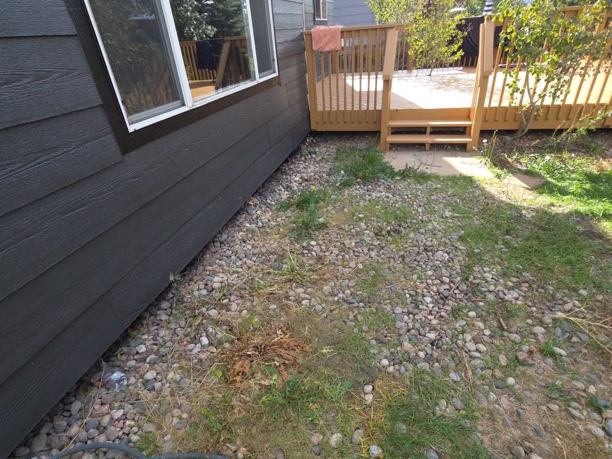 The same side yard cleared back to the rock and grass