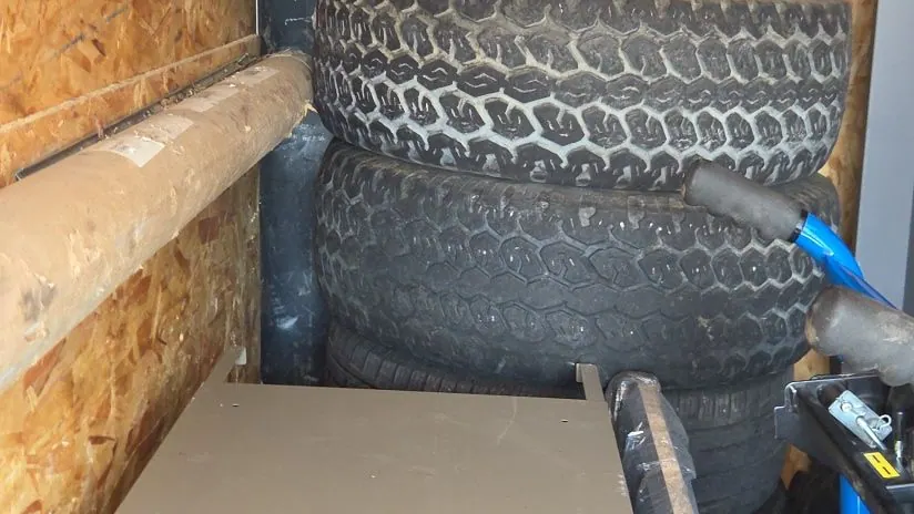 Tires and a fridge loaded in the cargo trailer