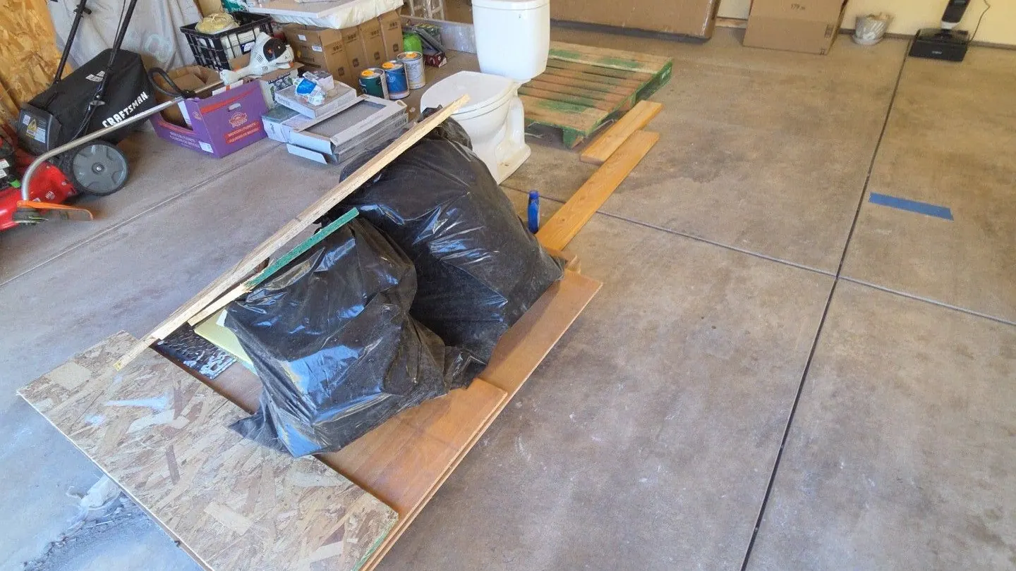 Drywall scraps bags and leftover materials in an empty commercial bay